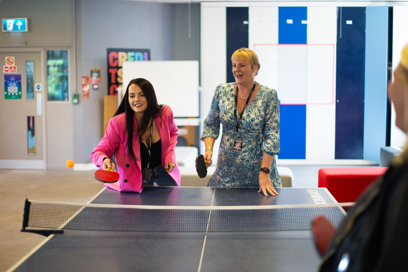 Customer Development Team playing a game of ping pong.