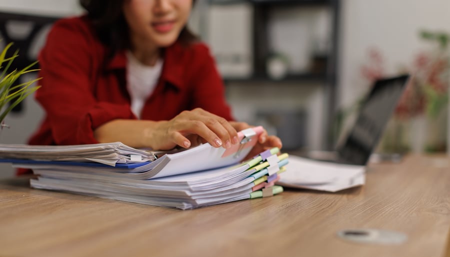 A woman going through business credit files