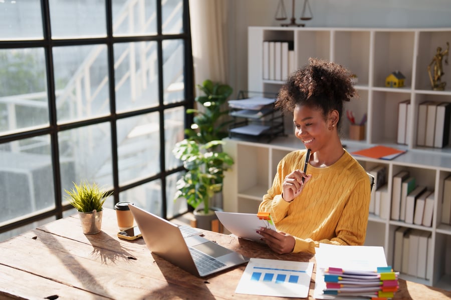 A woman performing a business credit score check in a sunny office