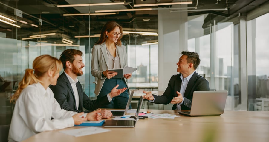 A woman presenting something to colleagues during a business meeting