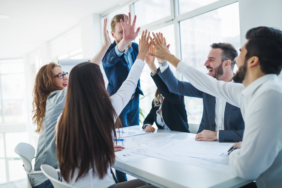 A business team high-fiving