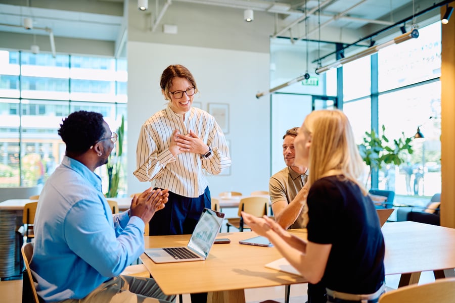 A smiling credit team in a meeting