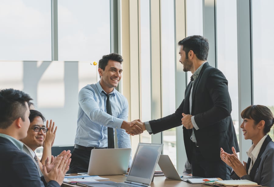 Two men shaking hands in a business meeting