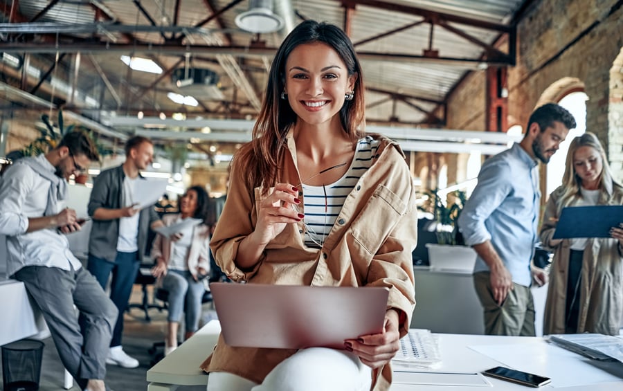 A woman celebrating business success in an office setting