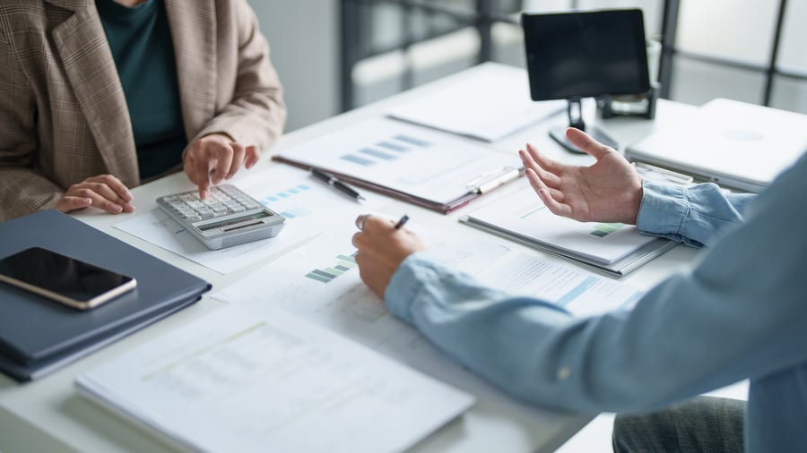 Colleagues looking over payment data in an office