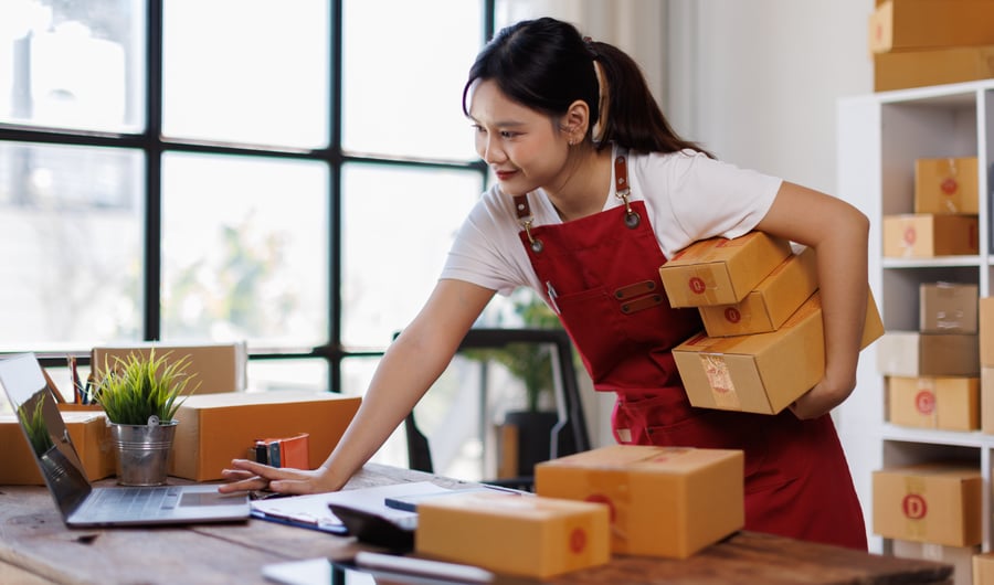 A woman cataloguing boxes as part of her small business