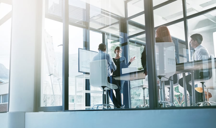 A meeting in a glass office building