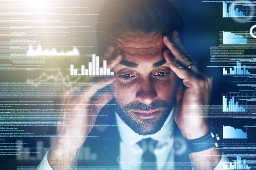 A businessman stressed about the cost of late payments