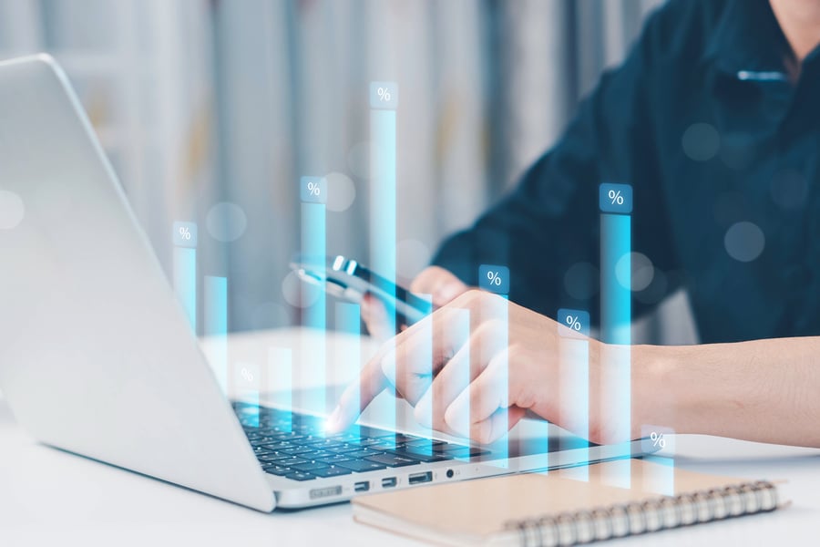 A person looking at credit risk data on a laptop in an office