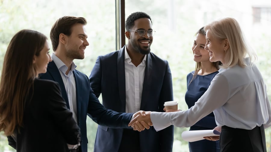 A group of business colleagues shaking hands