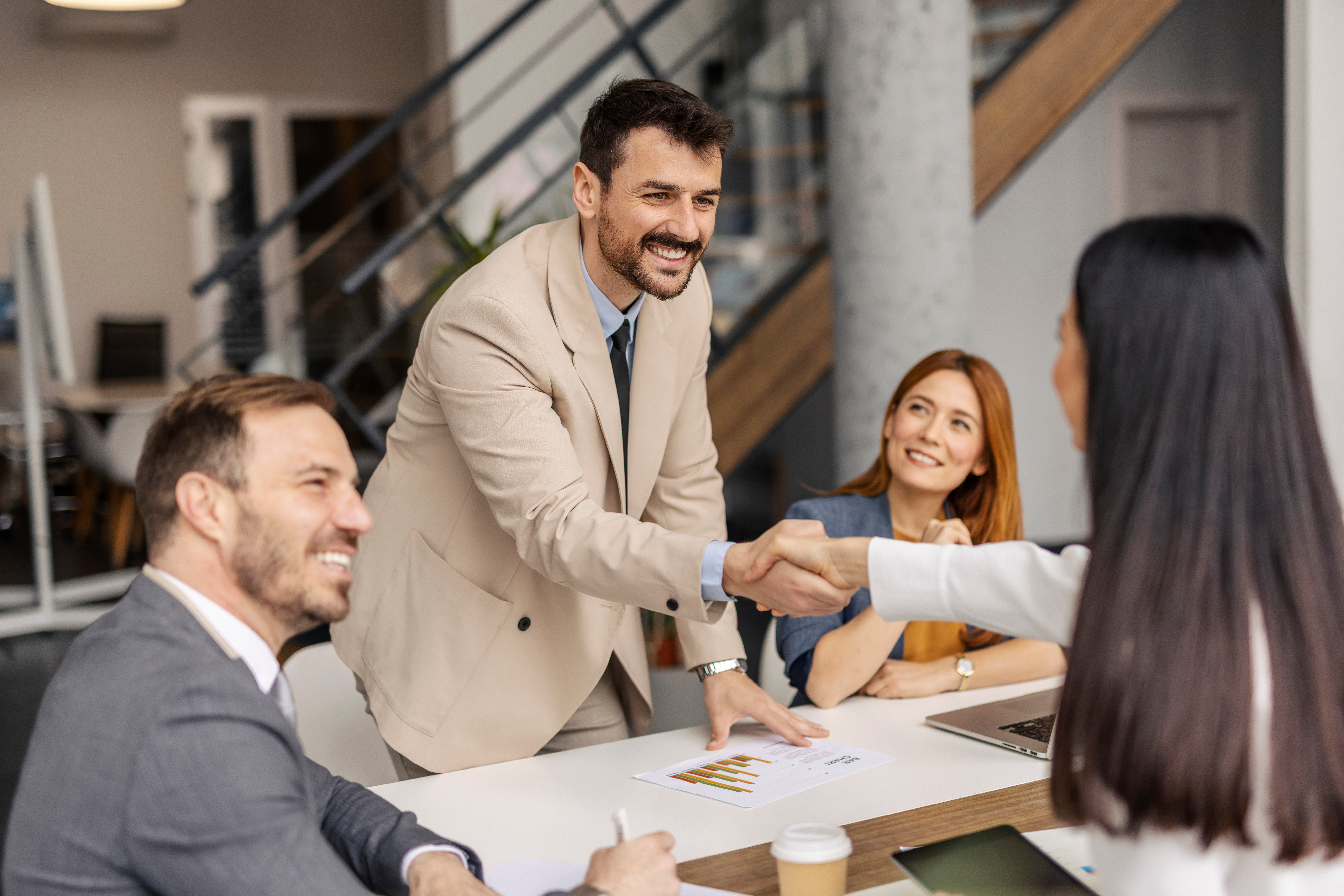 Shaking hands after signing a business deal