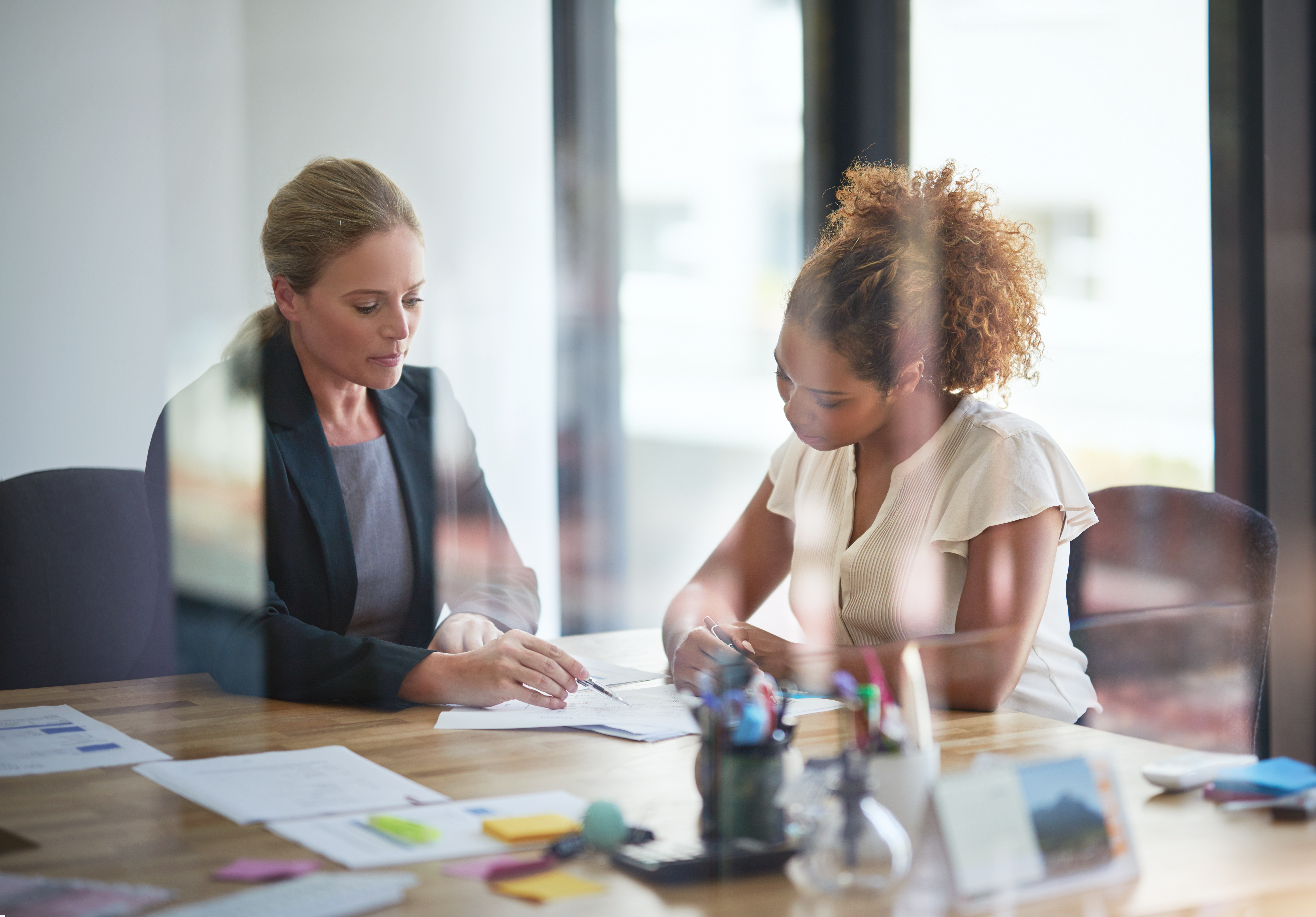 Two women looking over business documents together